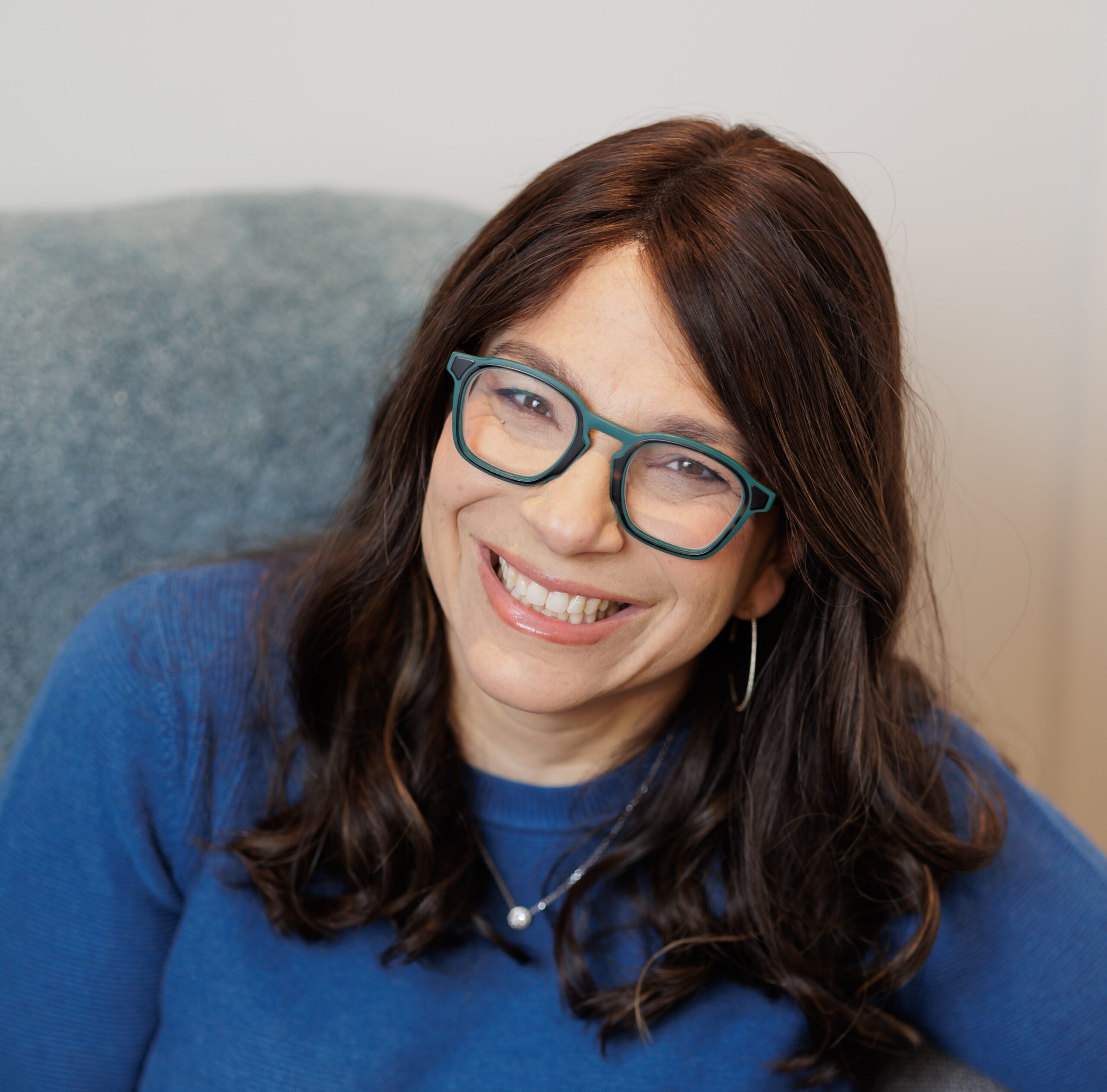 Smiling woman with glasses.