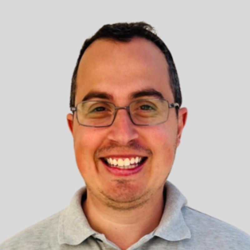 Smiling man with glasses.